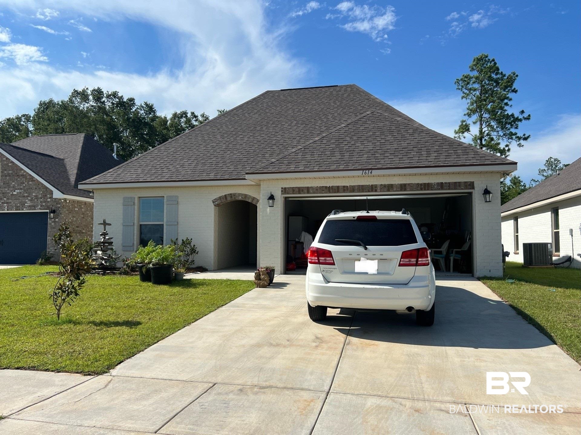 1614 Fenton Circle Foley, AL 36535 - Photo 1 of 3 View of front of house with a garage, a front yard, and central AC
