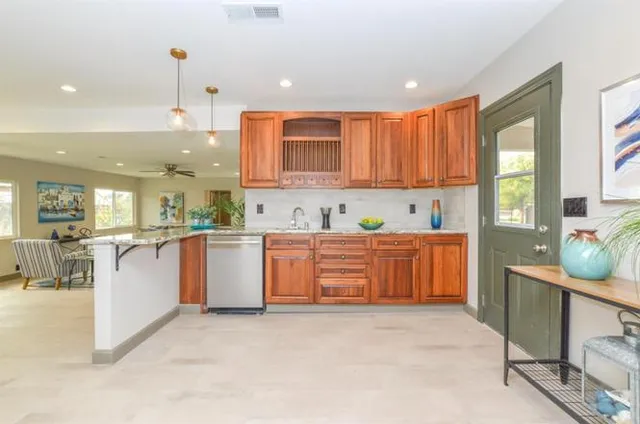 a kitchen with sink a stove and cabinets