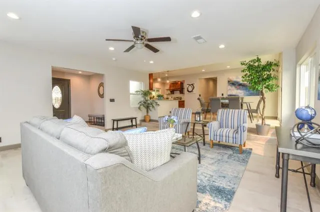 a living room with furniture and a large window