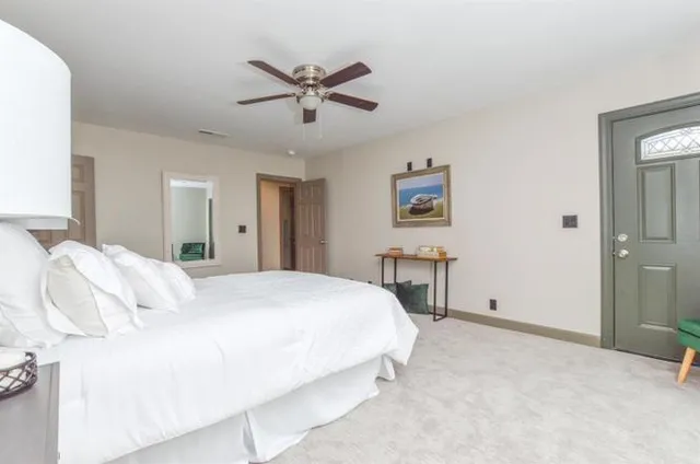 a bedroom with a bed and a chandelier
