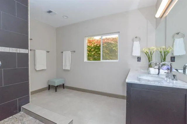 a bathroom with a sink toilet and mirror