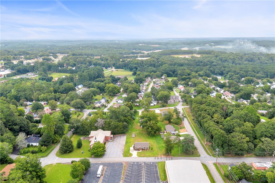 308 Verner Street Walhalla, SC 29691 - Photo 45 of 49 Mature trees and rolling hills surround the established neighborhood under a vast blue sky.