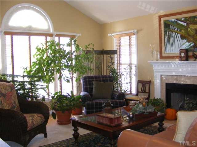 3224 Sandy Bluff Road Raleigh, NC 27616 - Photo 3 of 14 a living room with furniture a fireplace and a large window