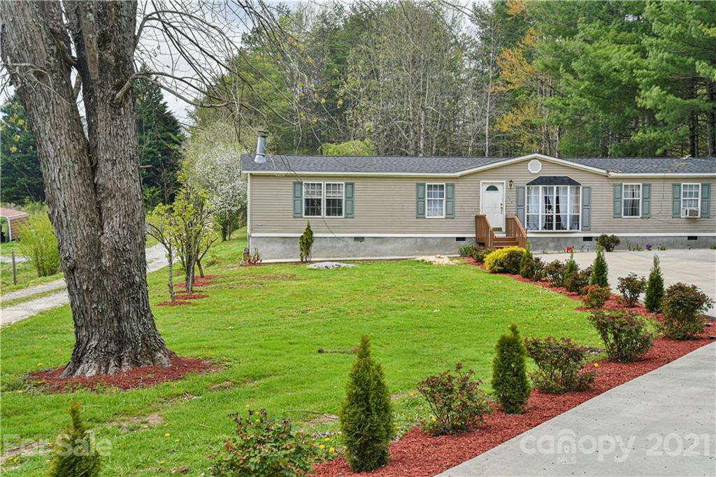 599 Pace Road Hendersonville, NC 28792 - Photo 2 of 24 a front view of a house with a yard and trees