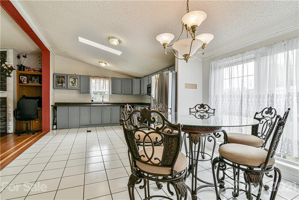 599 Pace Road Hendersonville, NC 28792 - Photo 7 of 24 a view of a dining room with furniture and chandelier