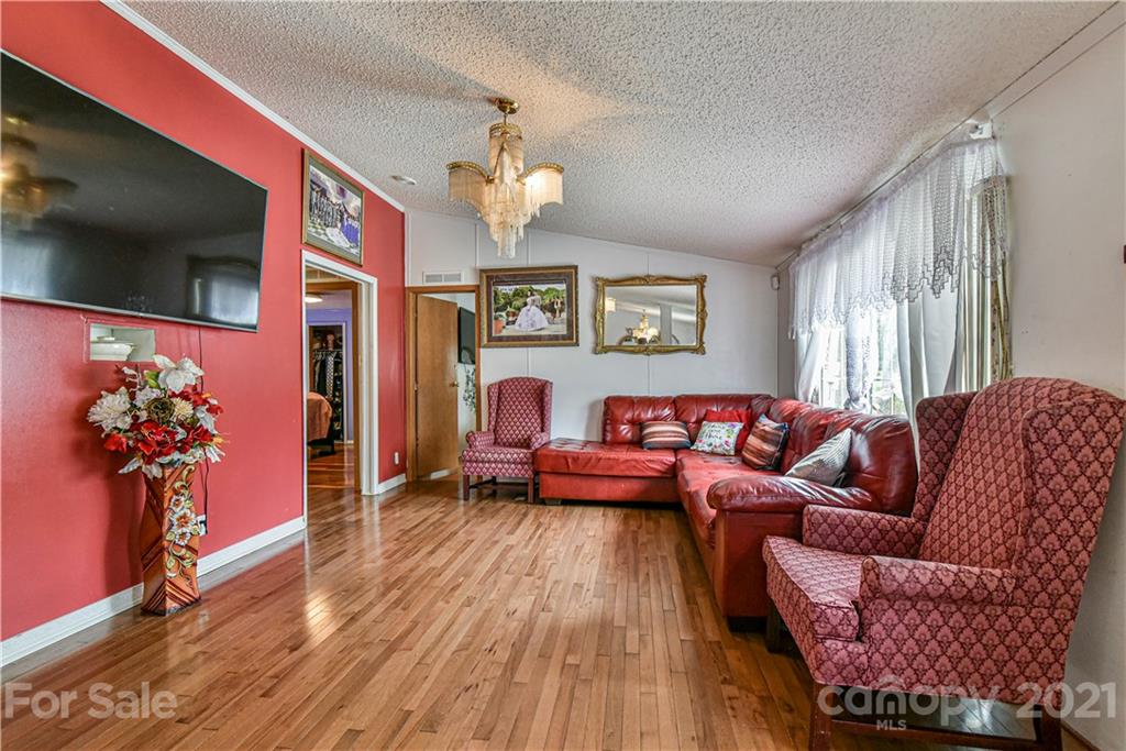 599 Pace Road Hendersonville, NC 28792 - Photo 8 of 24 a living room with furniture and a flat screen tv