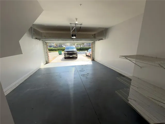 en empty room with windows and ceiling fan