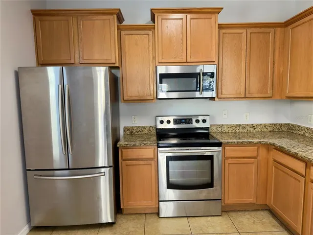 a kitchen with a refrigerator sink and microwave