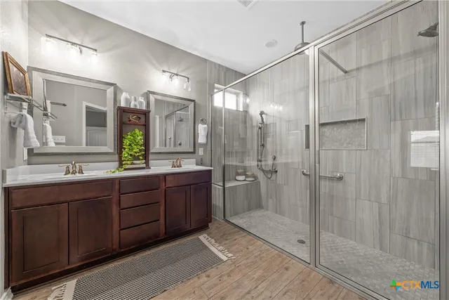 a bathroom with a double vanity sink and mirror