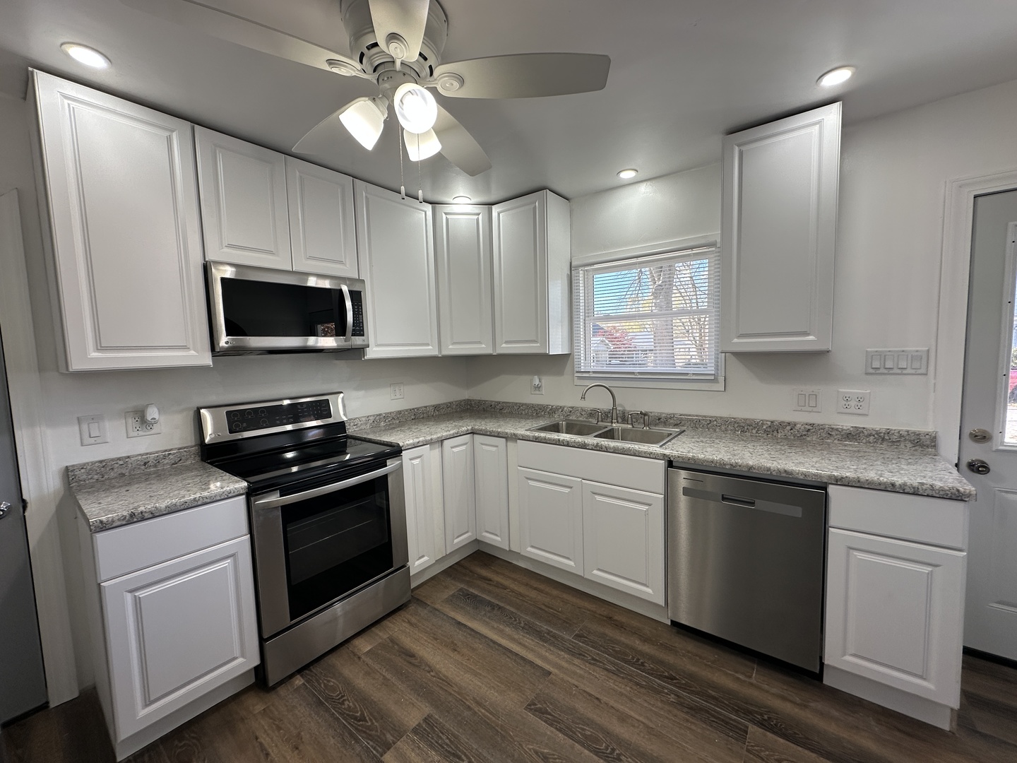 1202 East Jefferson Street Clinton, IL 61727 - Photo 3 of 19 a kitchen with stainless steel appliances granite countertop a sink and stove top oven