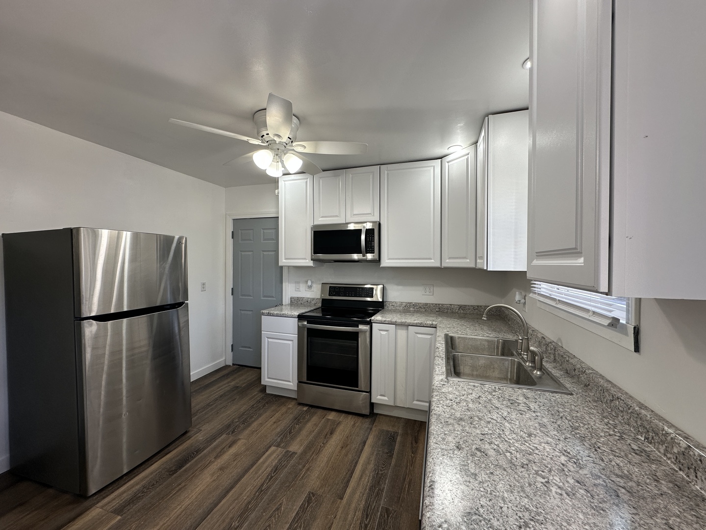 1202 East Jefferson Street Clinton, IL 61727 - Photo 4 of 19 a kitchen with a refrigerator sink and microwave