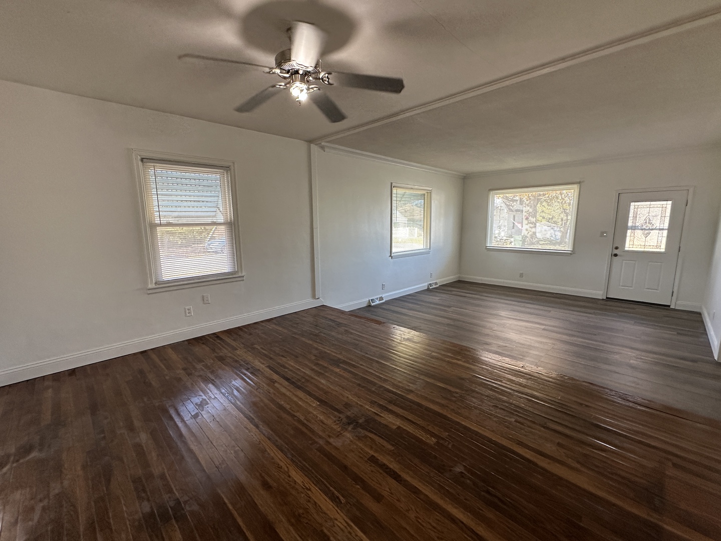 1202 East Jefferson Street Clinton, IL 61727 - Photo 6 of 19 a view of an empty room with wooden floor and a window