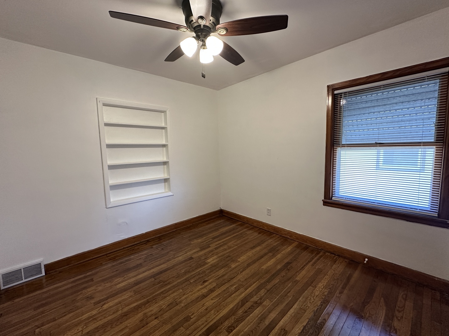 1202 East Jefferson Street Clinton, IL 61727 - Photo 10 of 19 a view of empty room with wooden floor and fan