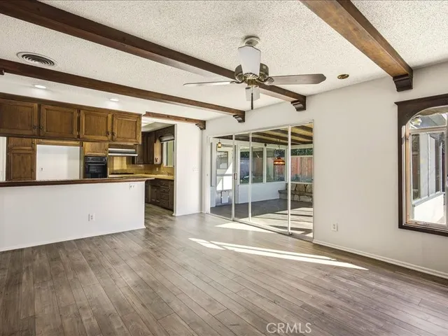 a view of empty room with wooden floor and cabinet