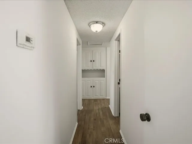 a view of a hallway with wooden floor