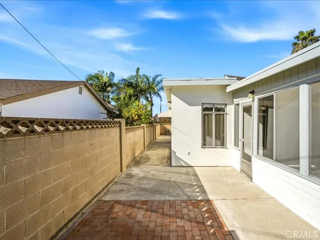 a view of an house with backyard space and balcony