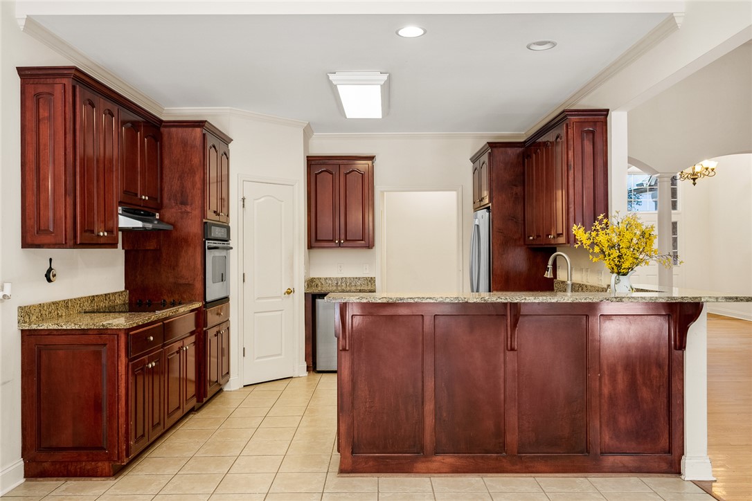 135 Sunset Bay Boulevard Seneca, SC 29672 - Photo 14 of 50 A well-appointed kitchen features rich wood cabinetry and ample counter space for culinary endeavors.