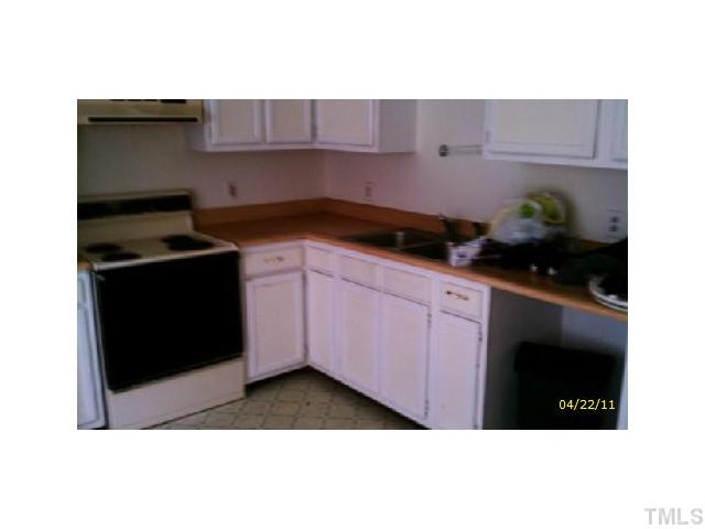 2713 Milburnie Road Raleigh, NC 27610 - Photo 3 of 6 a kitchen with granite countertop a cabinets and a stove