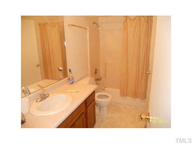2713 Milburnie Road Raleigh, NC 27610 - Photo 6 of 6 a bathroom with a sink a toilet and shower