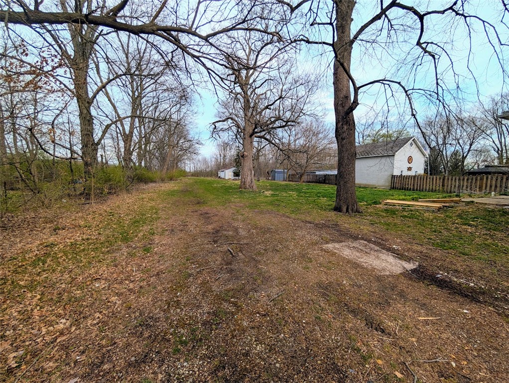 10796 Preble County Line Road Brookville, OH 45309 - Photo 3 of 33 This expansive yard features mature trees, offering ample space and natural charm.