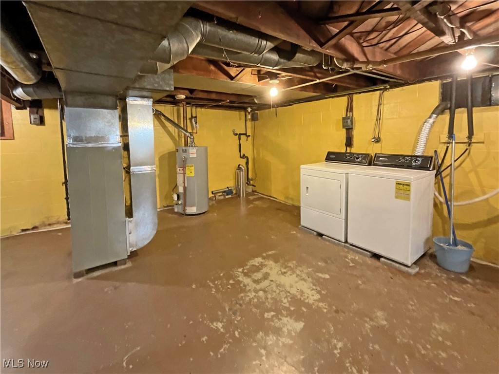 63 Mc Coll Road Colliers, WV 26035 - Photo 13 of 17 Basement with heating unit, gas water heater, and washer and dryer