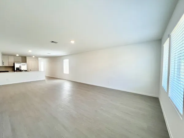 an empty room with a empty space and windows