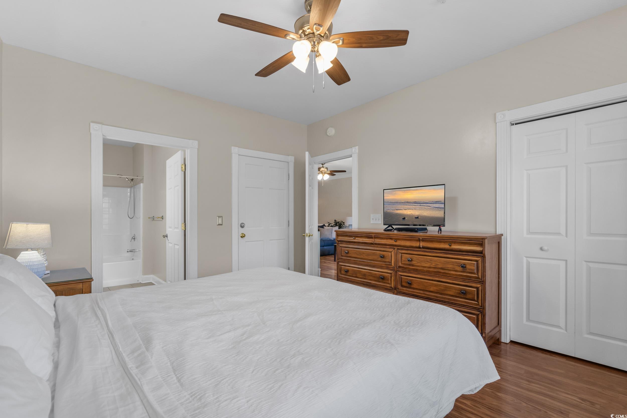 4823 Magnolia Lake Drive, Unit 101 Myrtle Beach, SC 29577 - Photo 18 of 35 Bedroom with dark wood-style floors, a ceiling fan, and a closet