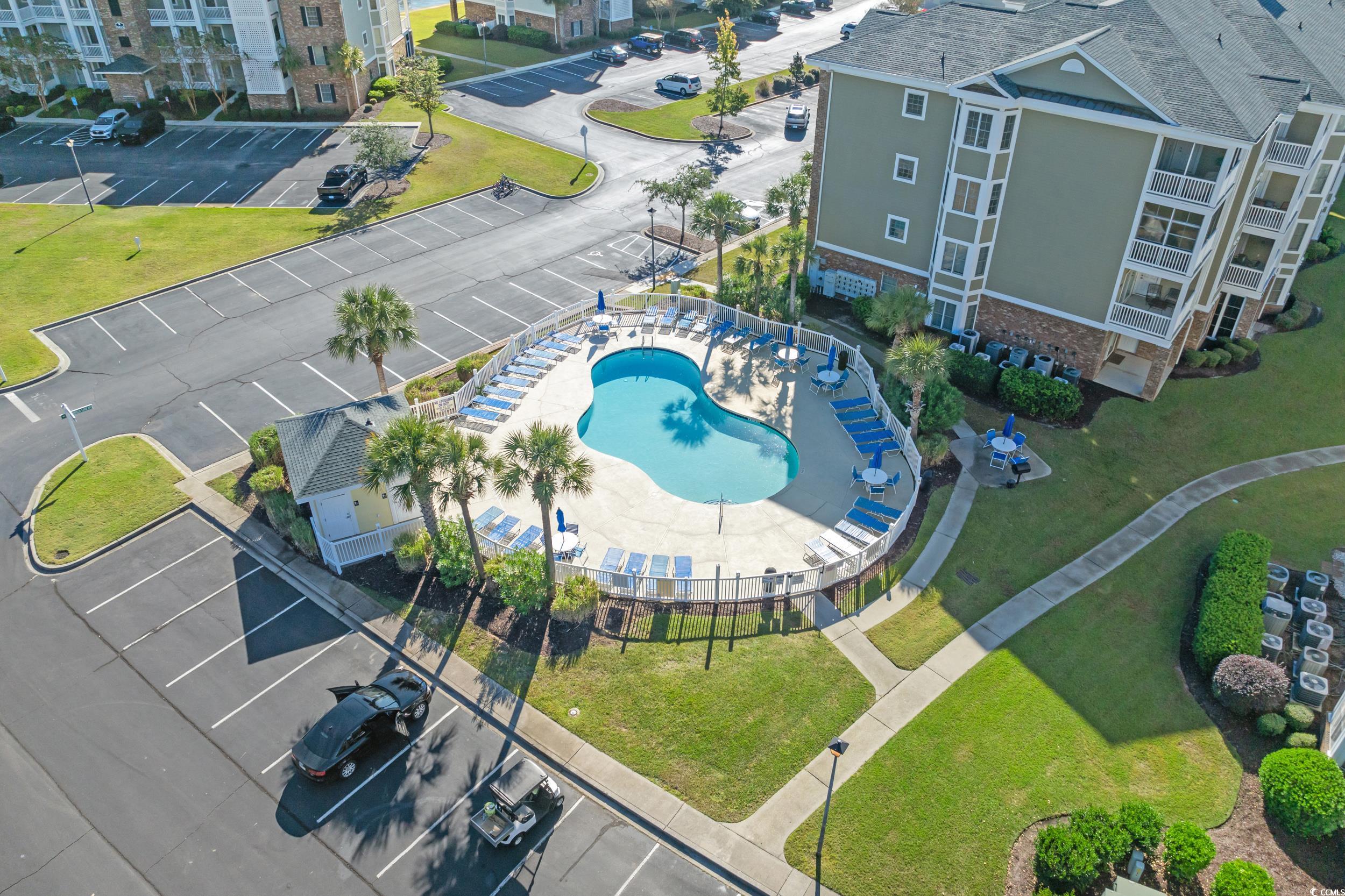 4823 Magnolia Lake Drive, Unit 101 Myrtle Beach, SC 29577 - Photo 25 of 35 Drone / aerial view of a pool area and apartment complex