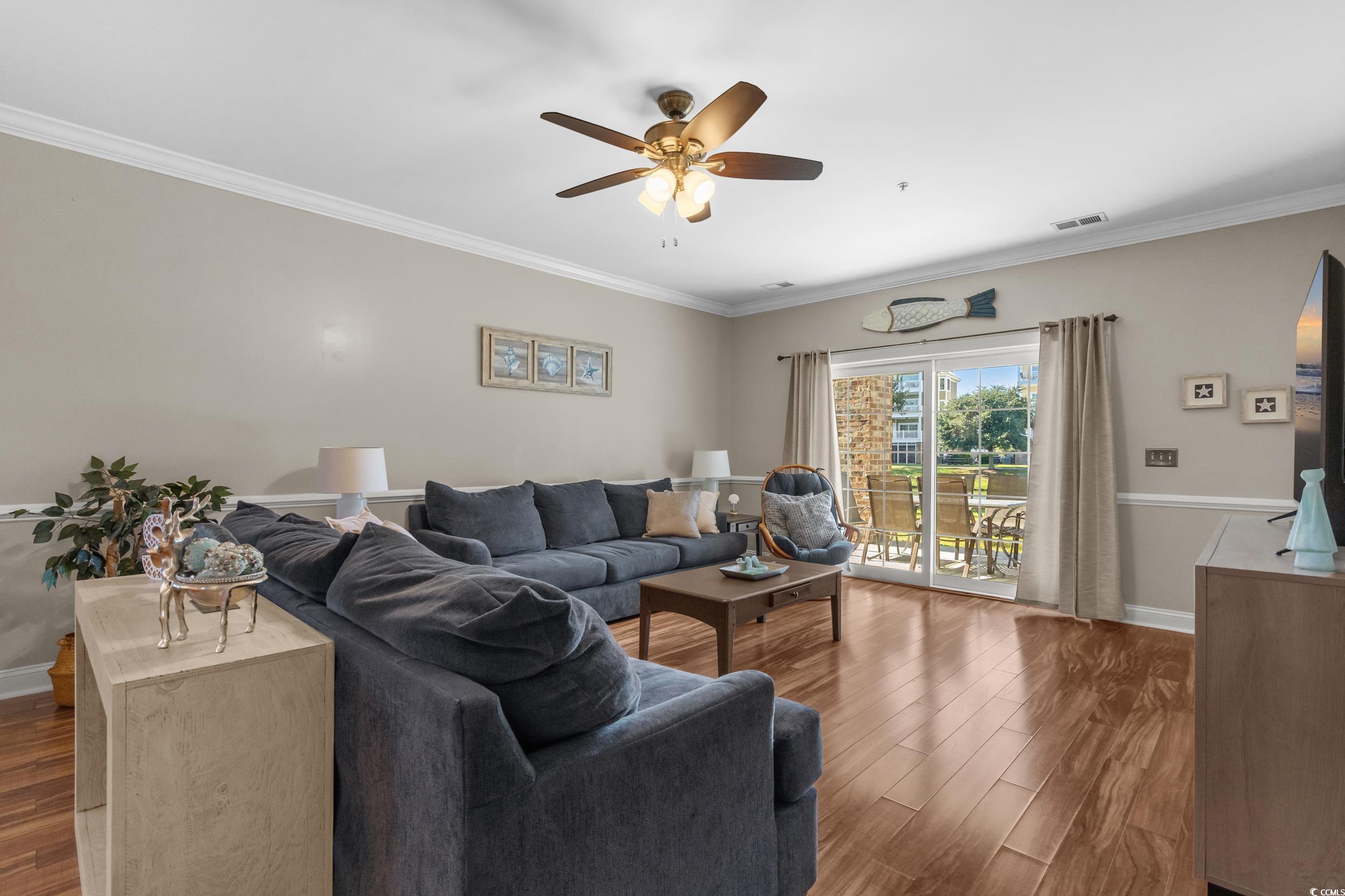 4823 Magnolia Lake Drive, Unit 101 Myrtle Beach, SC 29577 - Photo 3 of 35 Living room with crown molding, wood finished floors, and a ceiling fan