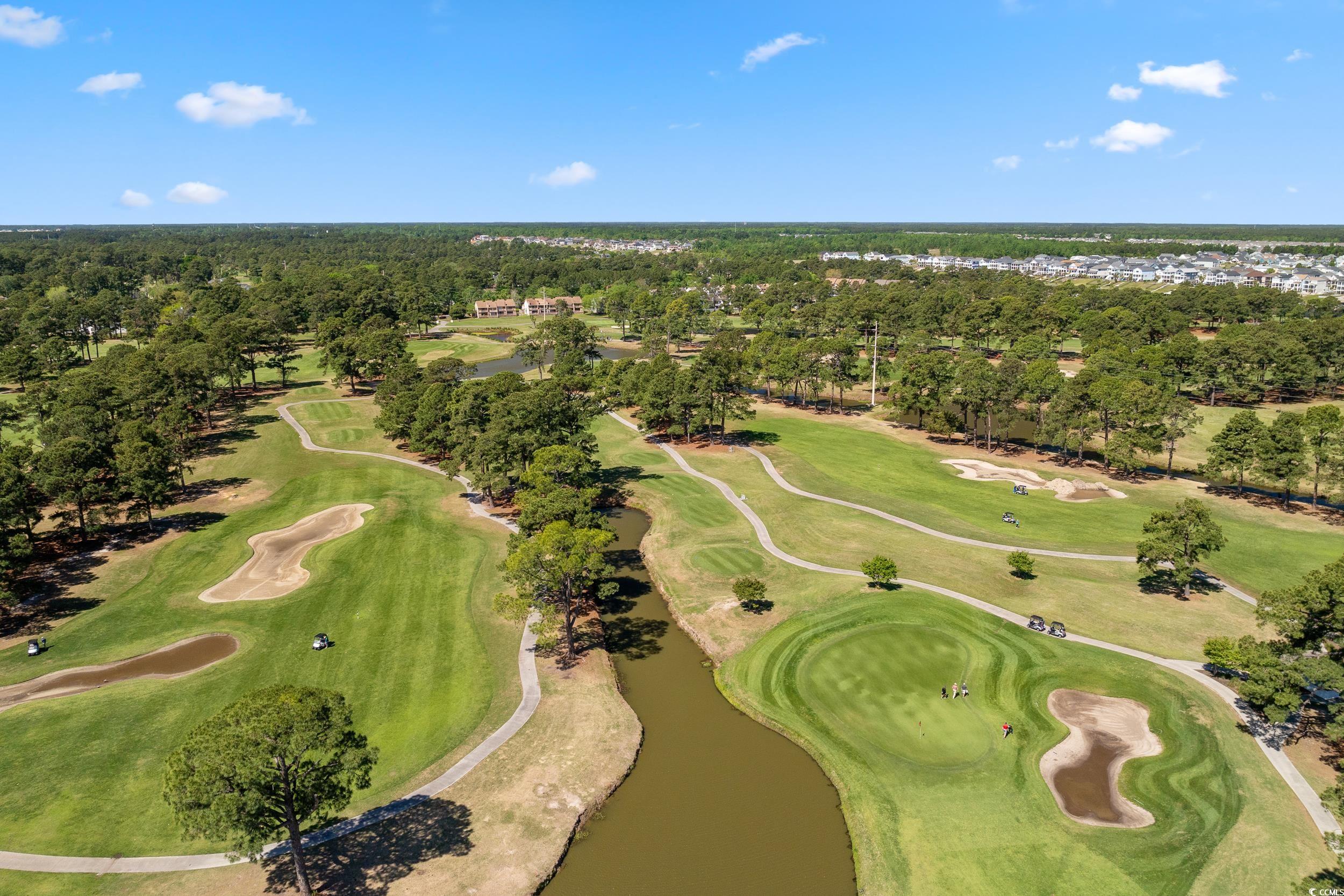4823 Magnolia Lake Drive, Unit 101 Myrtle Beach, SC 29577 - Photo 28 of 35 Aerial view of property and surrounding area with a golf course