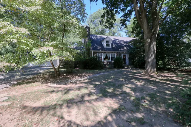 a view of house with a tree in front