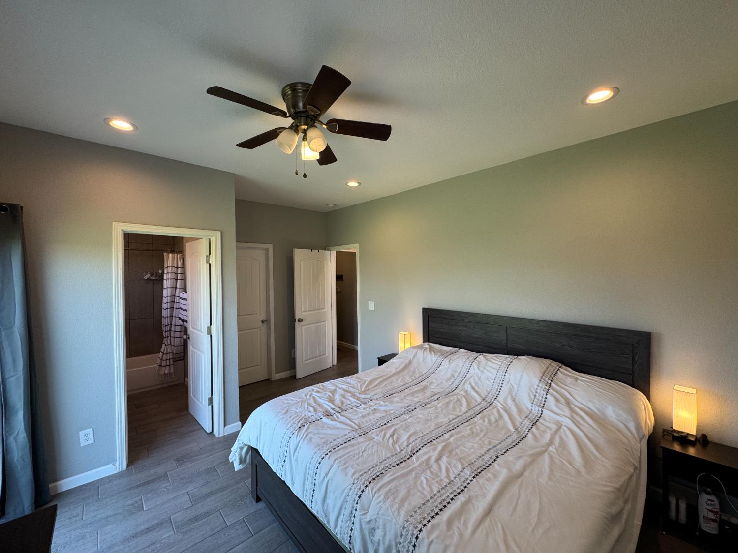 1650 North Olive Avenue Turlock, CA 95382 - Photo 12 of 21 a bedroom with a bed and a chandelier