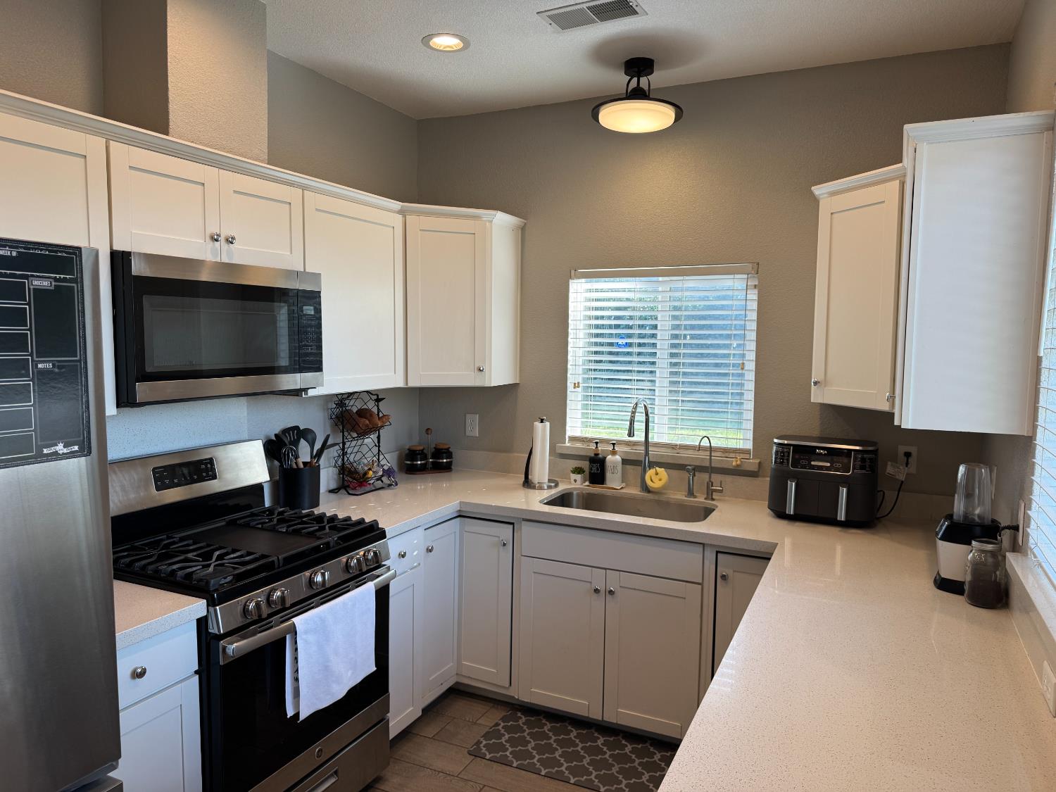 1650 North Olive Avenue Turlock, CA 95382 - Photo 4 of 21 a kitchen with a sink stove top oven and cabinets