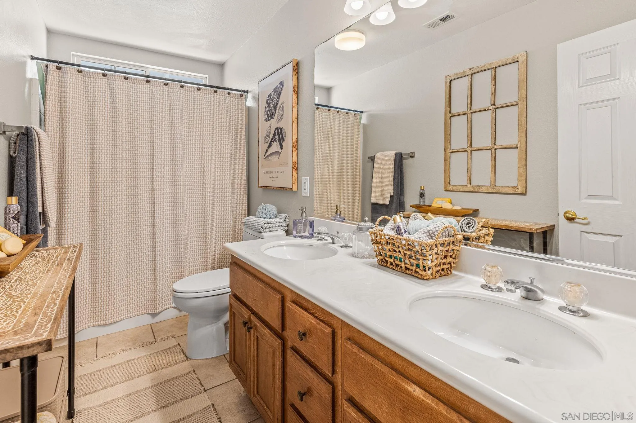 6882 Tradewinds Drive Carlsbad, CA 92011 - Photo 8 of 20 a bathroom with double vanity sink a mirror and a shower