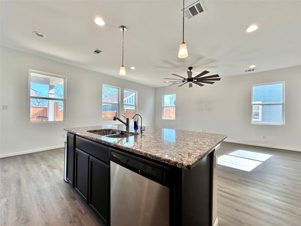 202 Pebblestream Pass Taylor, TX 76574 - Photo 35 of 35 a kitchen with stainless steel appliances granite countertop a sink a window and wooden floor