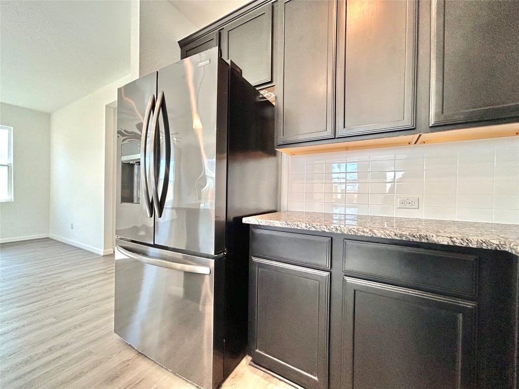 202 Pebblestream Pass Taylor, TX 76574 - Photo 14 of 35 a kitchen with granite countertop a refrigerator and a sink
