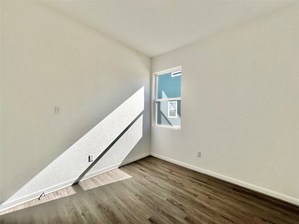 202 Pebblestream Pass Taylor, TX 76574 - Photo 16 of 35 a view of a room with wooden floor and white walls