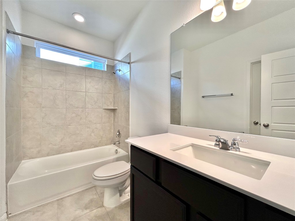 202 Pebblestream Pass Taylor, TX 76574 - Photo 19 of 35 a bathroom with a sink a toilet and shower