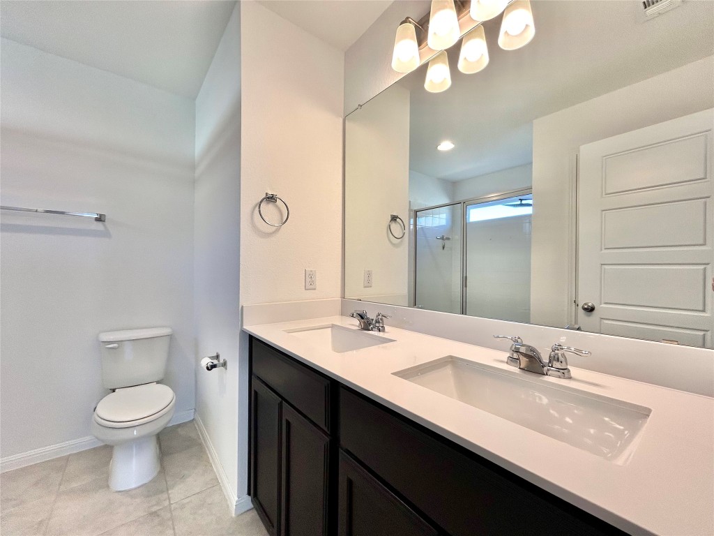 202 Pebblestream Pass Taylor, TX 76574 - Photo 24 of 35 a bathroom with a sink a toilet and a mirror