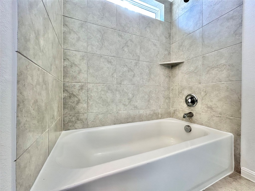 202 Pebblestream Pass Taylor, TX 76574 - Photo 31 of 35 a bathroom with a bathtub