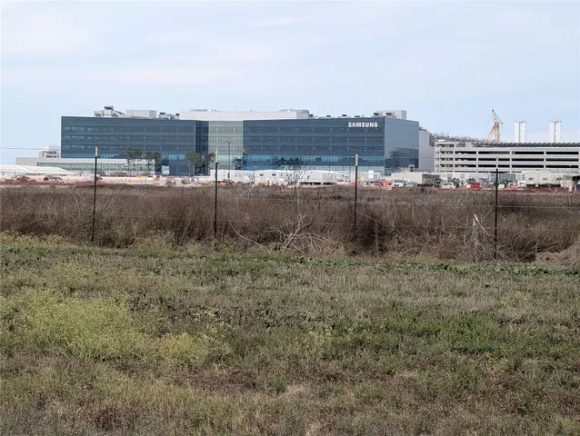 a view of patio with table and chairs under an umbrella