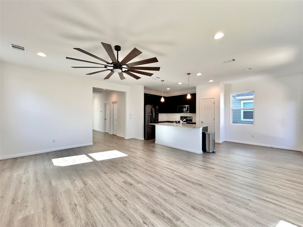 202 Pebblestream Pass Taylor, TX 76574 - Photo 8 of 35 a view of an empty room with window and wooden floor