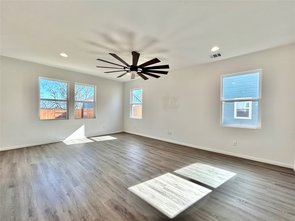 202 Pebblestream Pass Taylor, TX 76574 - Photo 9 of 35 a view of an empty room with wooden floor and a window
