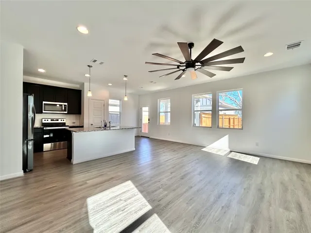 a view of kitchen with sink and wooden floor