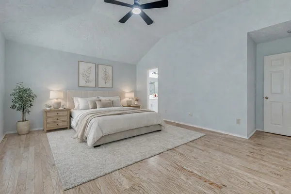 a view of empty room with wooden floor and window