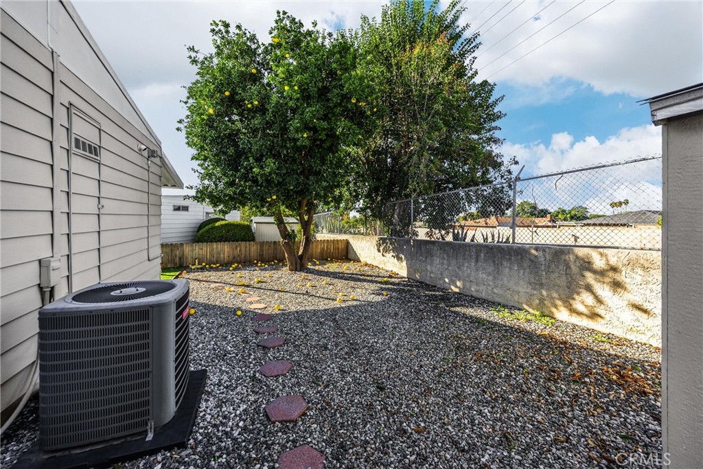 10210 Base Line Road, Unit 291 Rancho Cucamonga, CA 91701 - Photo 6 of 27 a view of a yard with wooden fence