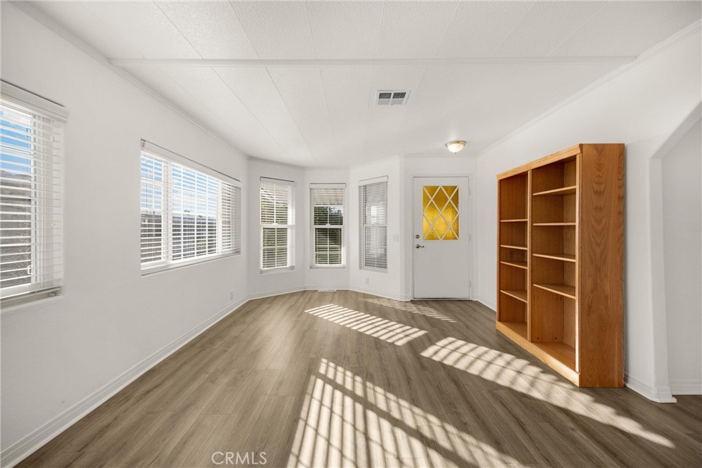 10210 Base Line Road, Unit 291 Rancho Cucamonga, CA 91701 - Photo 10 of 27 a view of empty room with wooden floor and windows