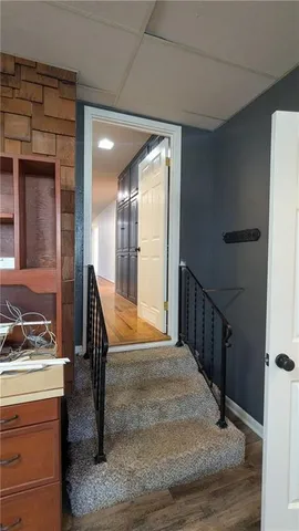 a open kitchen with stainless steel appliances kitchen island granite countertop a refrigerator and a stove