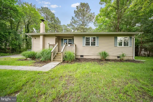 a front view of house with yard and trees
