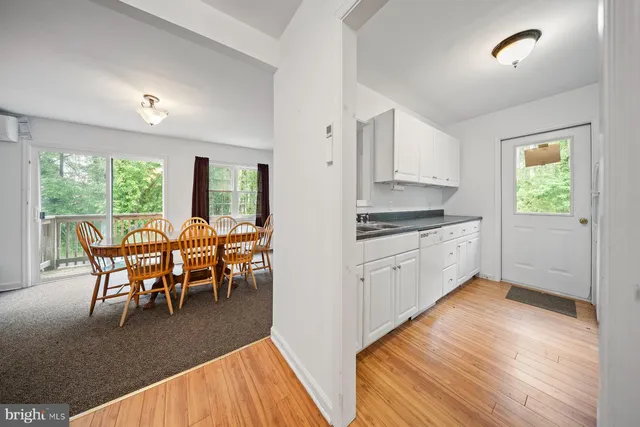 a kitchen with wooden floors and white appliances